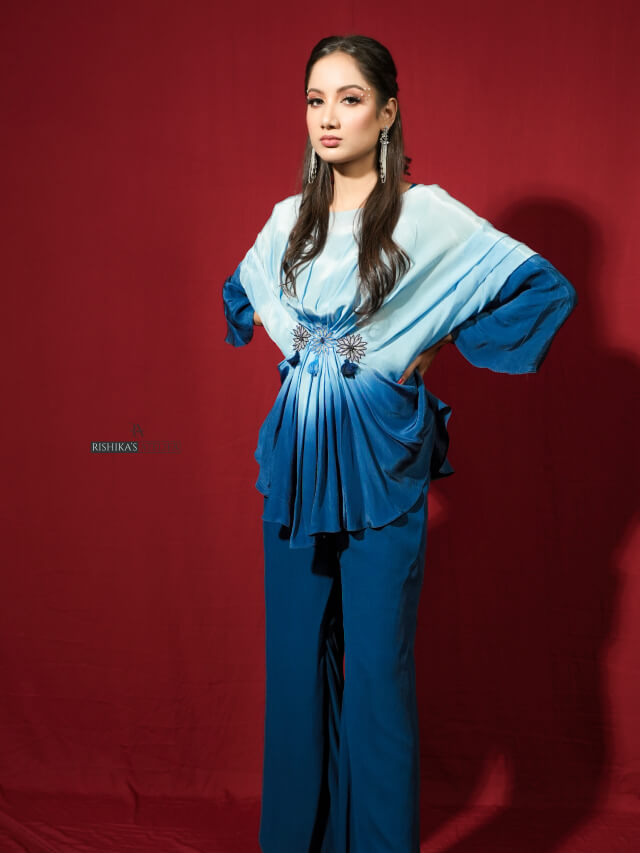 Blue ombre draped top with embellishment on the middle