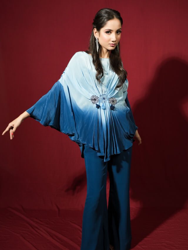 Blue ombre draped top with embellishment on the middle